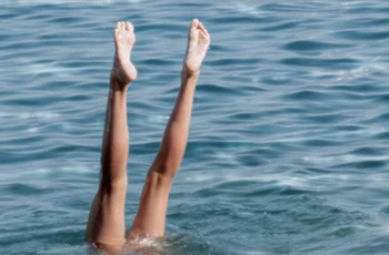 A woman's legs, diving into water